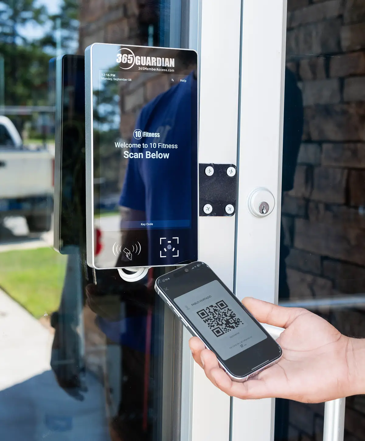 member scanning QR code at a 365 Guardian kiosk
